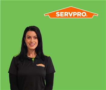 SERVPRO employee with dark hair wearing a black shirt in front of a green background