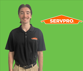 a man in front of a servpro background