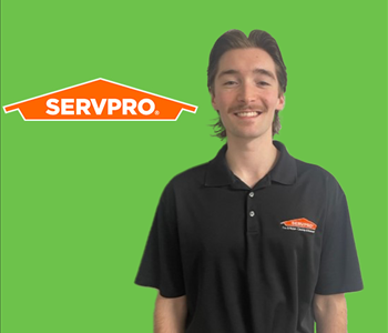 a man in front of a servpro background