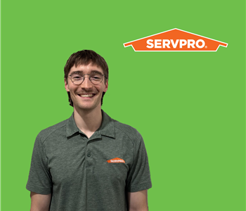 a man in front of a SERVPRO background