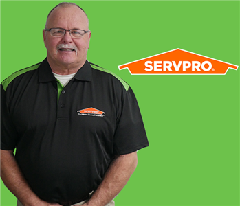Man in front of SERVPRO Logo on a green screen