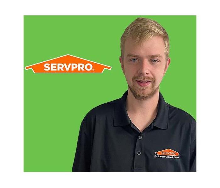 Guy in front of SERVPRO Green and Logo