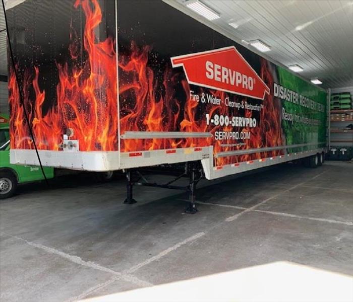 Semi trailer in a shop building with a fire and water wrap on the trailer